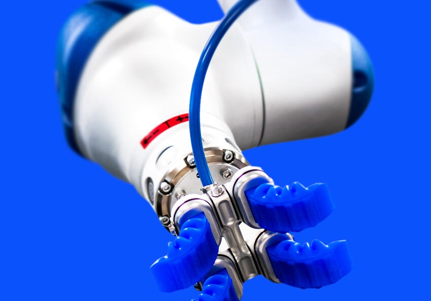 Close-up of a robotic arm with blue grippers against a blue background.